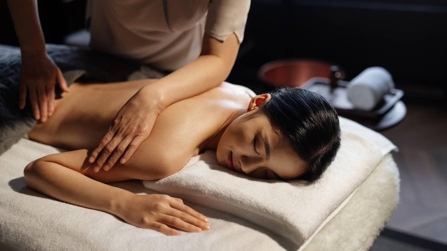 Woman gets a massage at luxury hotel spa