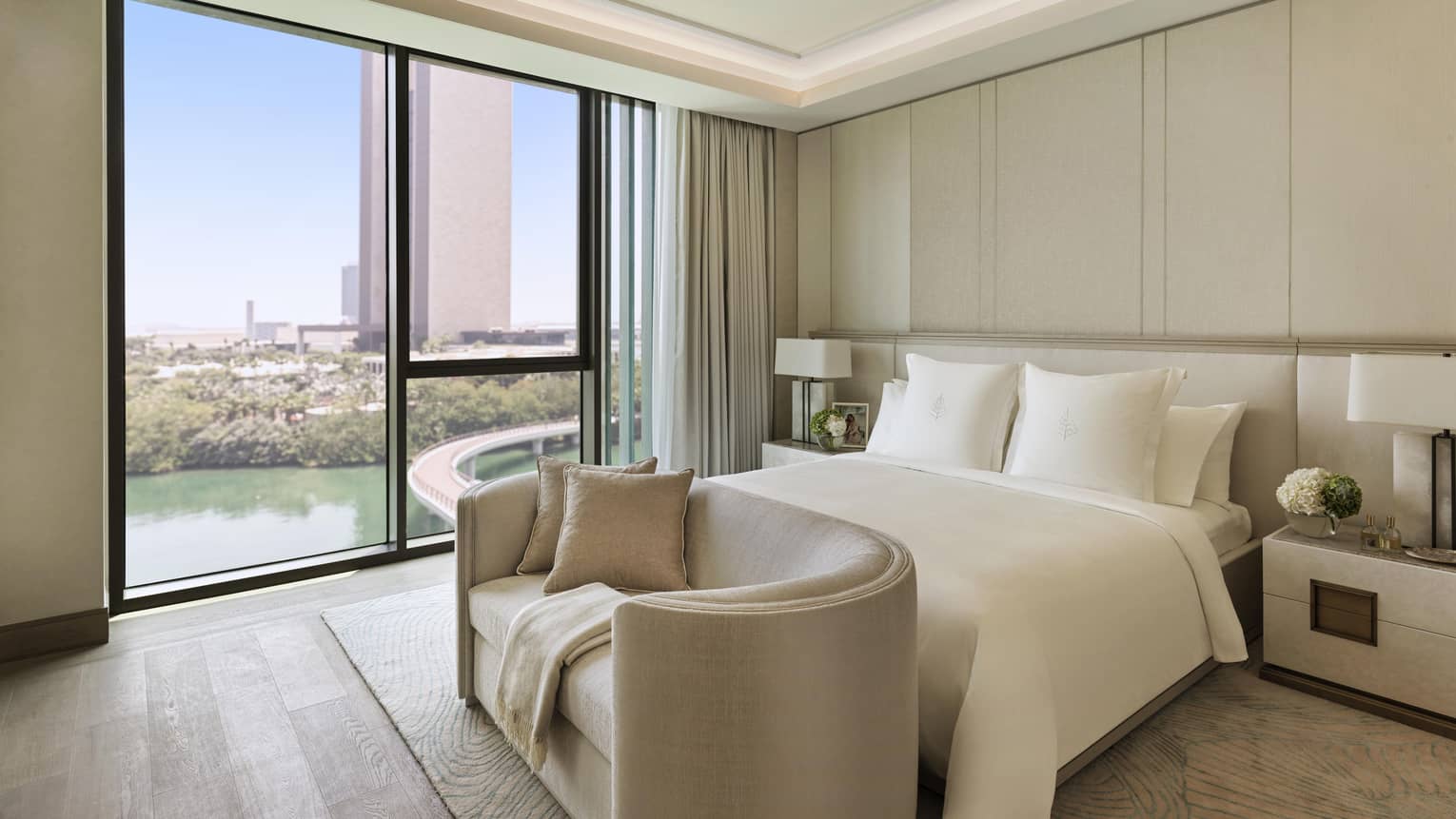 Primary bedroom with floor-to-ceiling windows and bay view