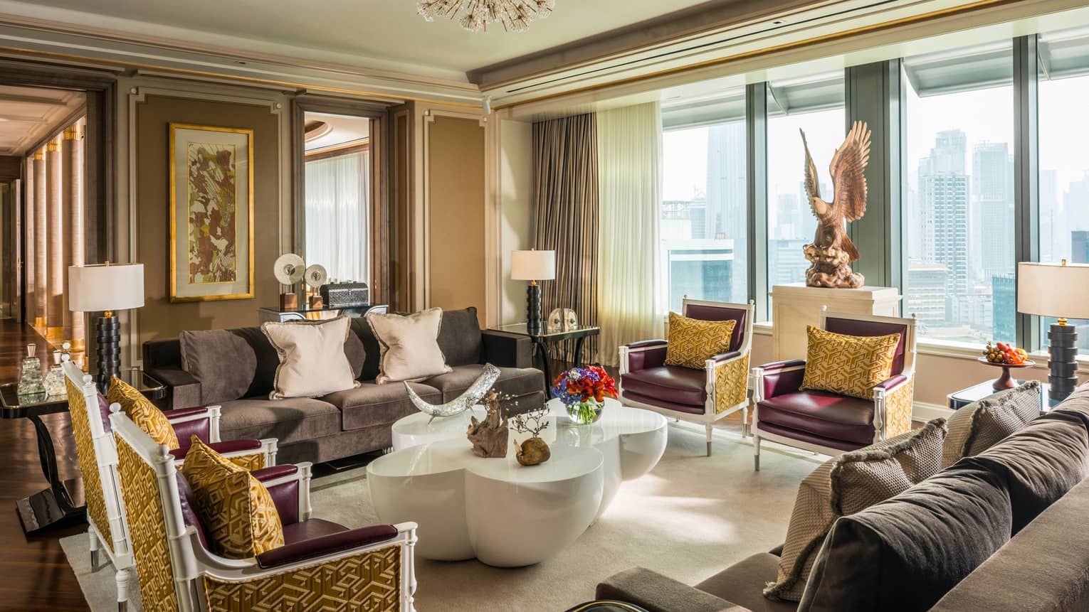Presidential Suite foyer with two sofas and four armchairs with accent pillows, large modern white coffee table, large eagle statue