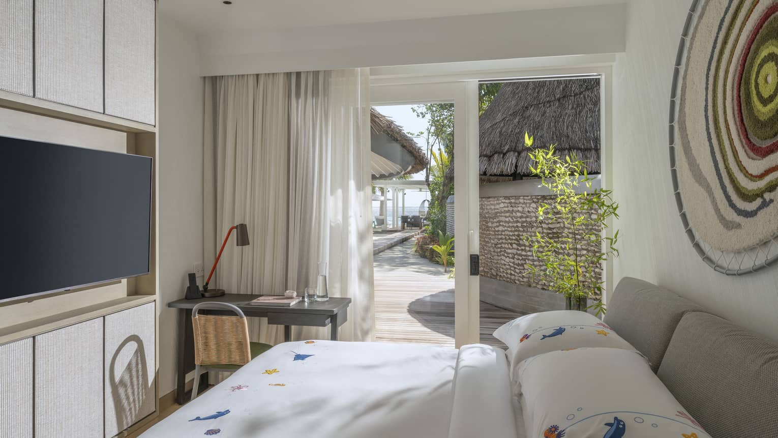Kids bedroom with desk and TV at luxury tropical resort