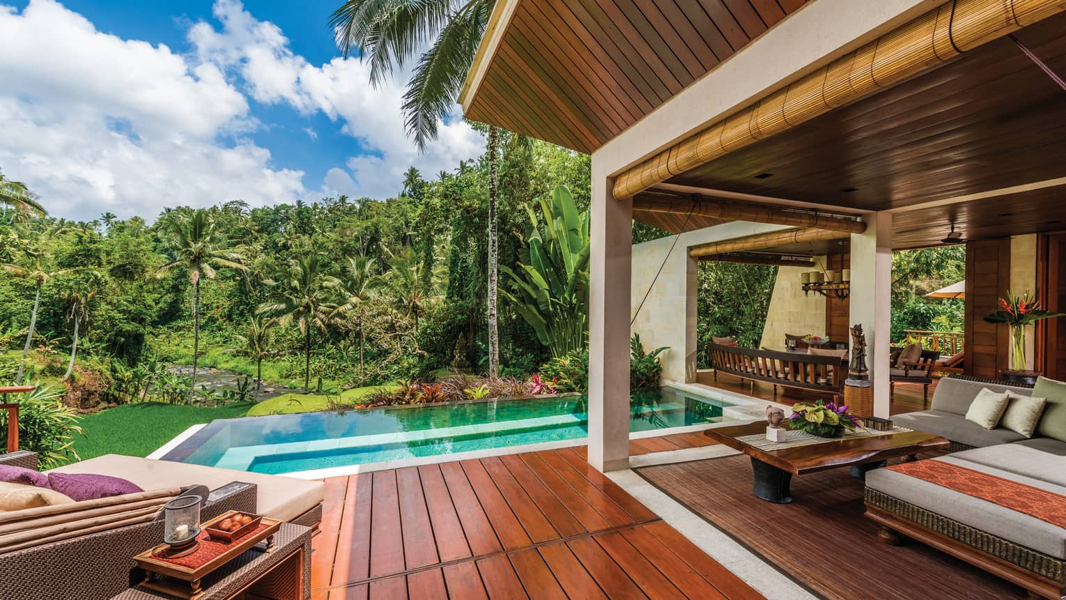 River-View Two Bedroom Villa patio with wood deck, blue plunge pool, large patio sofas with cushions, forest views