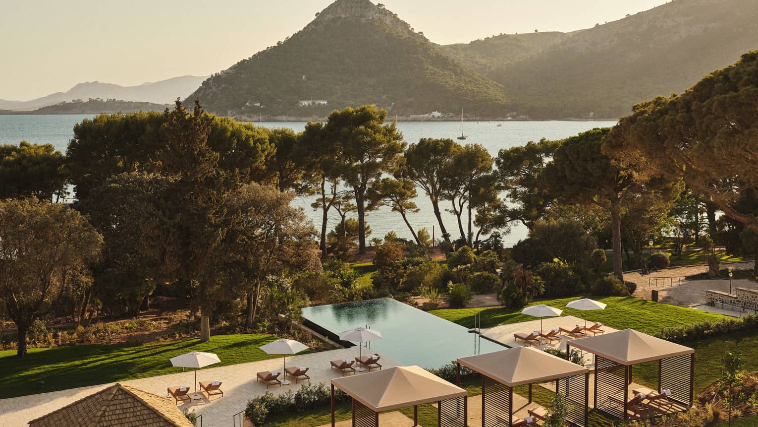 View of pool and ocean/mountain in background