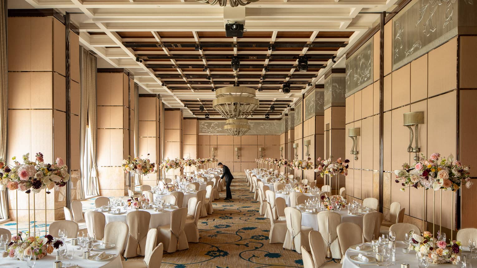 Indoor hotel ballroom set for wedding banquet
