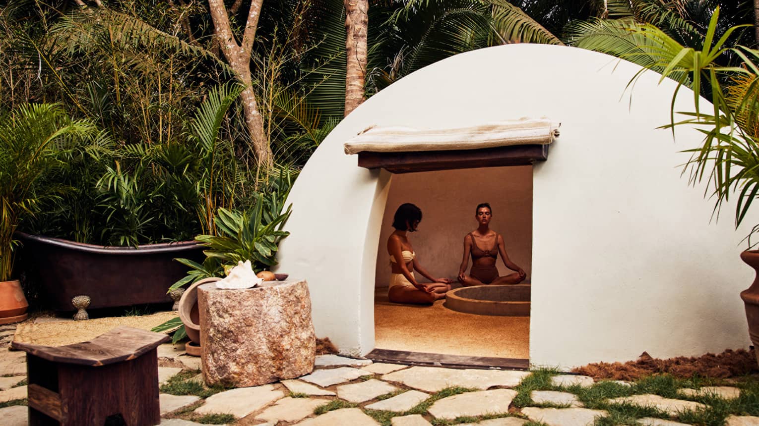 A heated dome shaped room surrounded by trees.