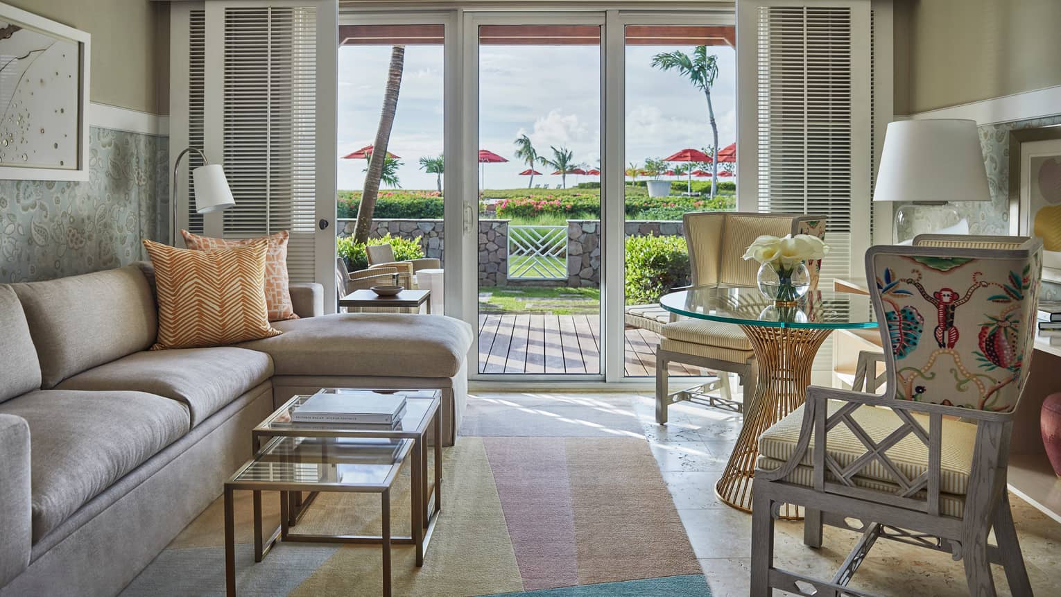 Ocean-Side room sectional sofa, glass tables, decorative chairs by sunny patio doors