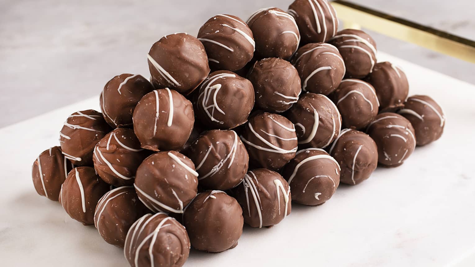  Milk chocolate truffle featuring a milk chocolate shell with milk chocolate ganache