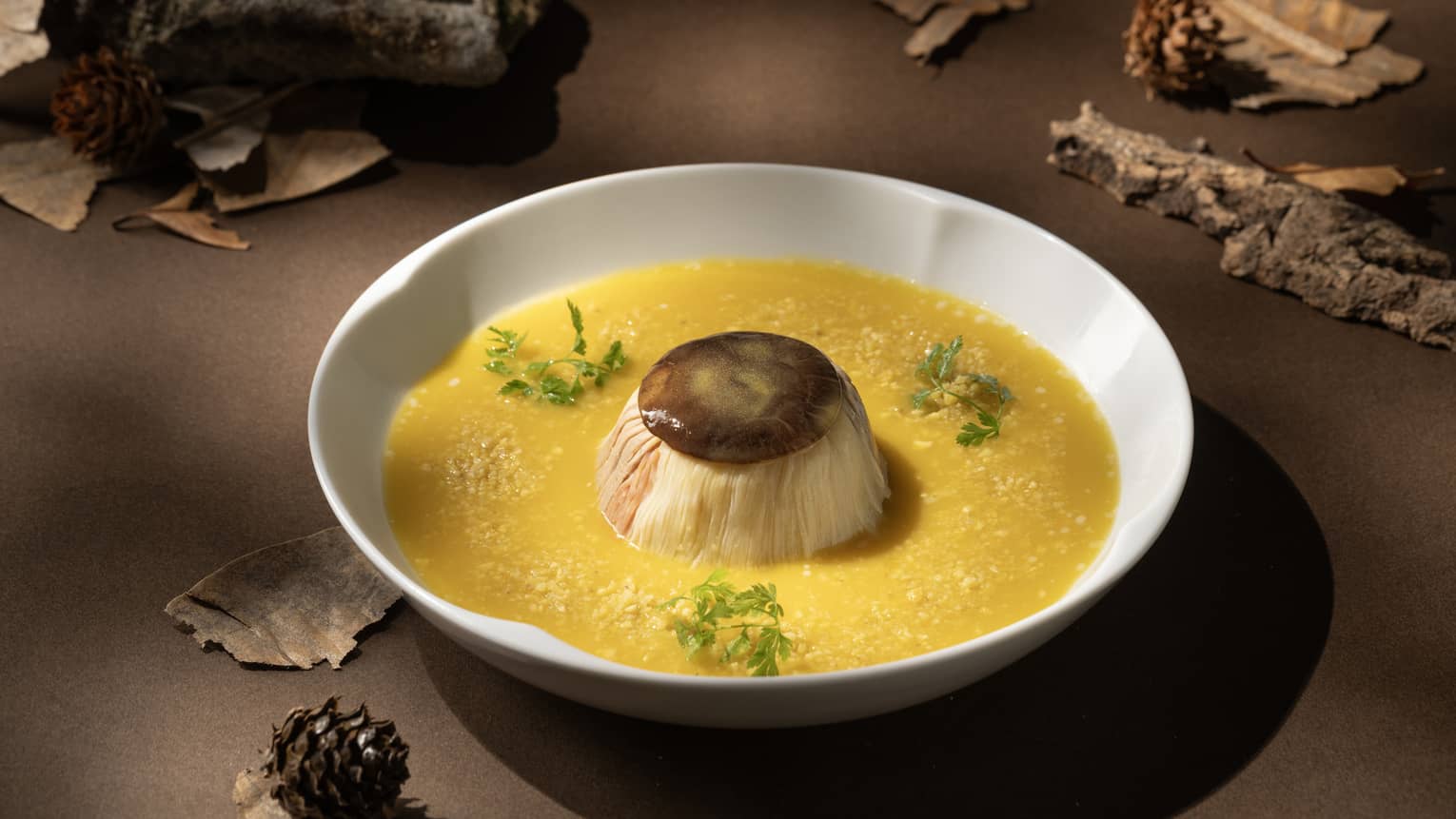 Steamed duck dish with orange sauce on white plate