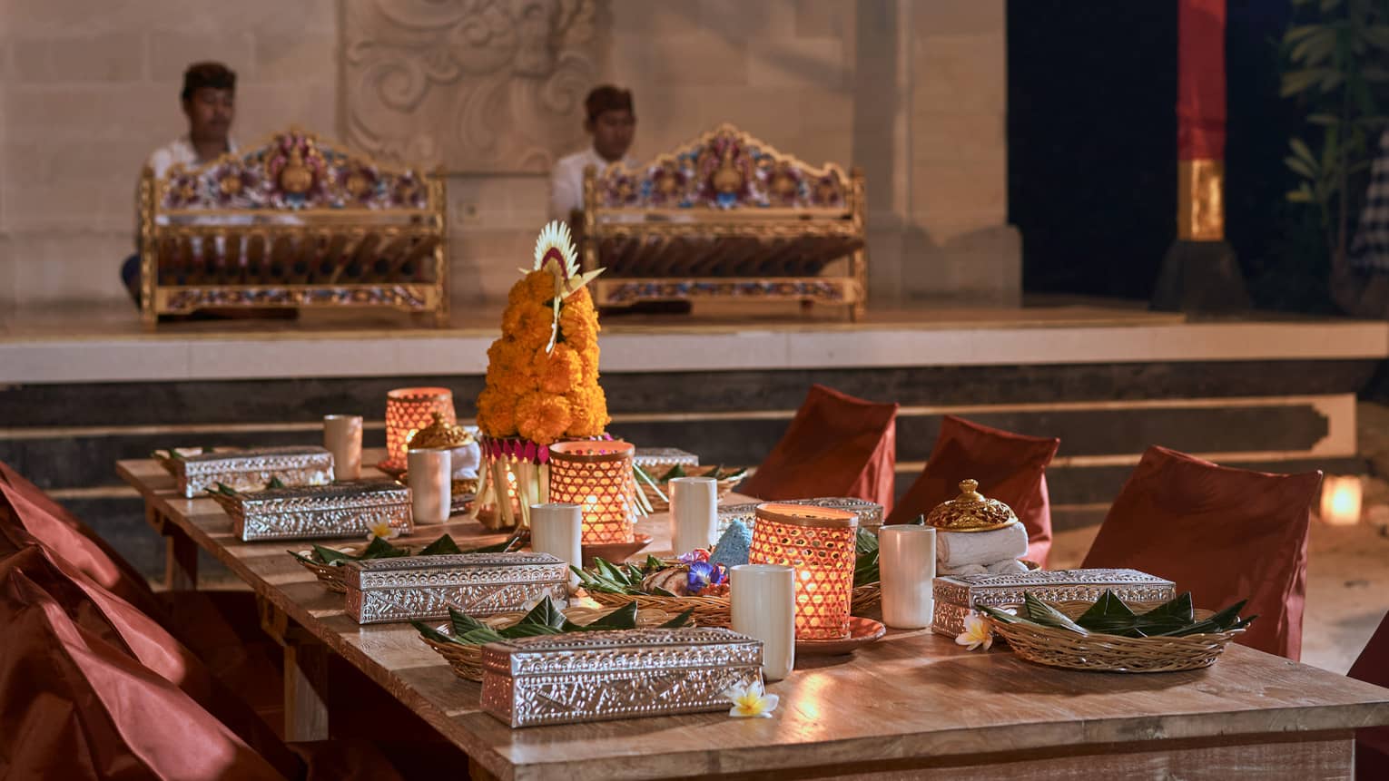 Rectangular table set with traditional Balinese adornments and candles for the Temple Ground Dinner