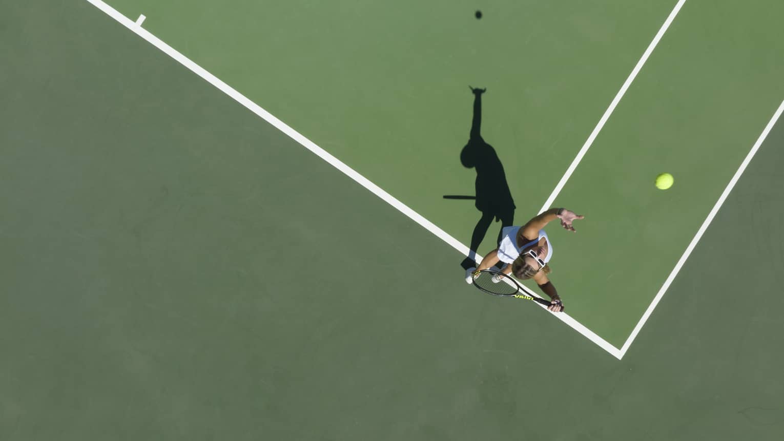 Aerial view of a tennis player mid serve