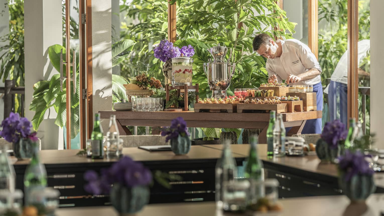 Chef puts finishing touches on canap�s in light-filled meeting room