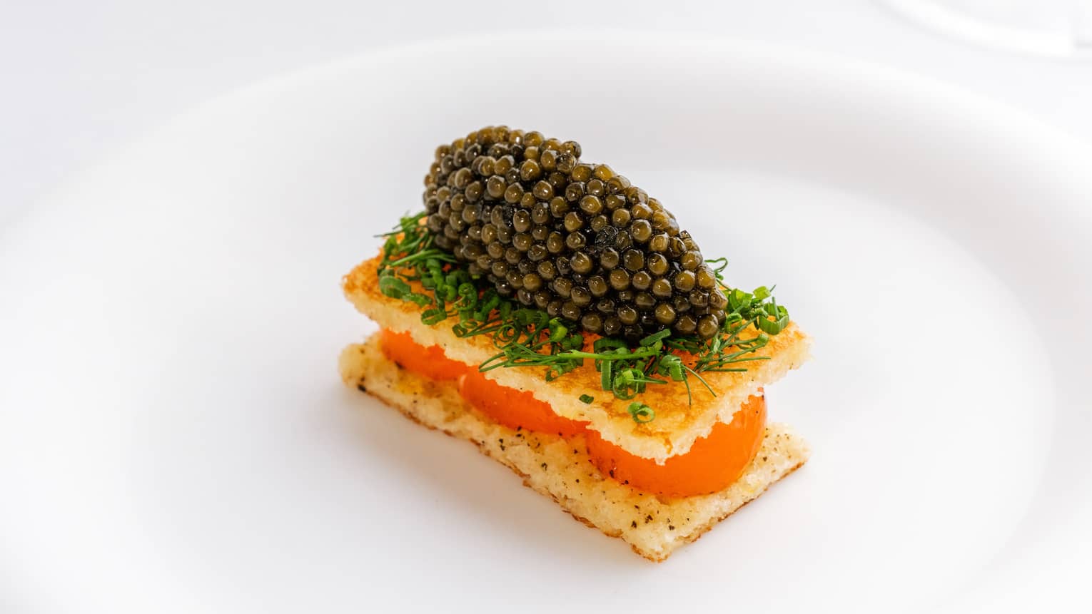 Plate of egg toast and caviar with herbs