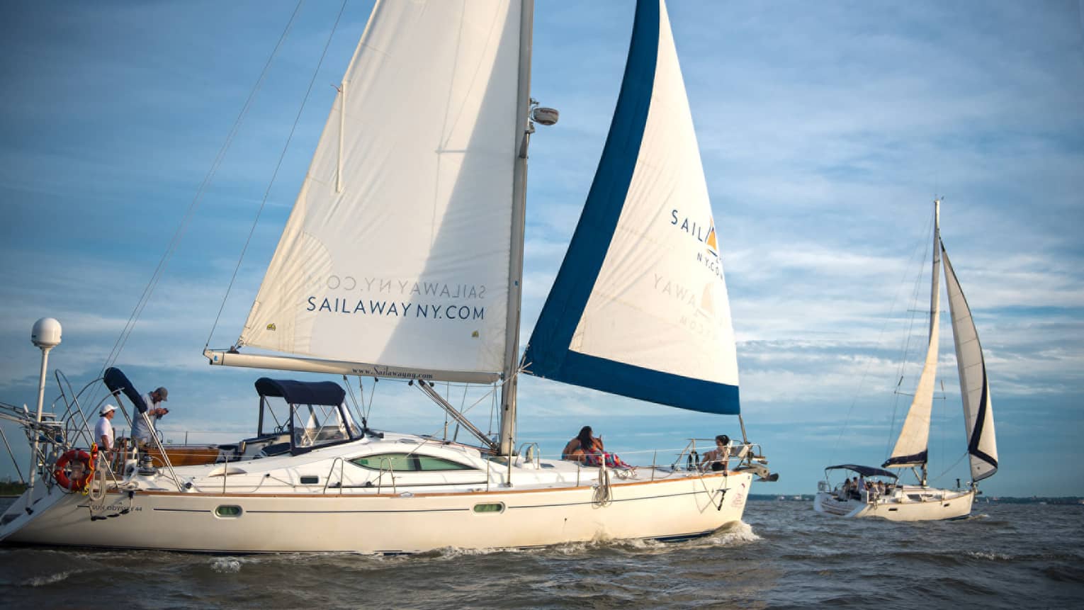 Two white sailboats at sea 