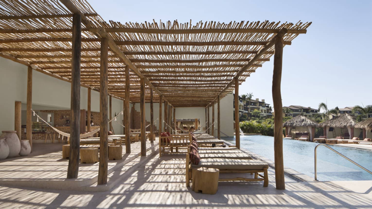 Poolside lounge under thatched roof