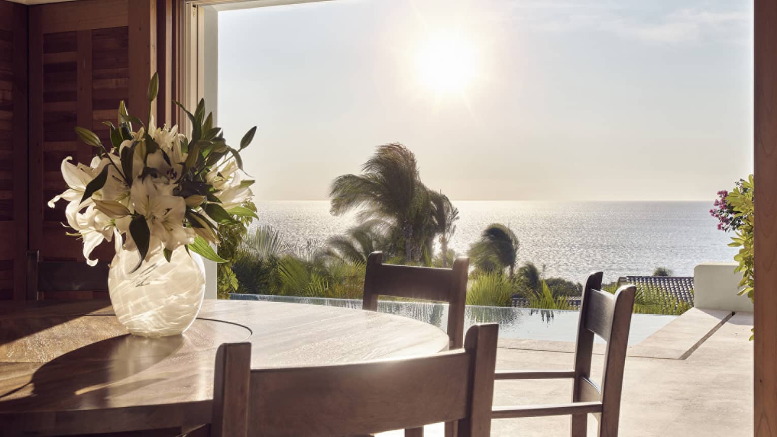Dining room opening to private terrace with pool and ocean view