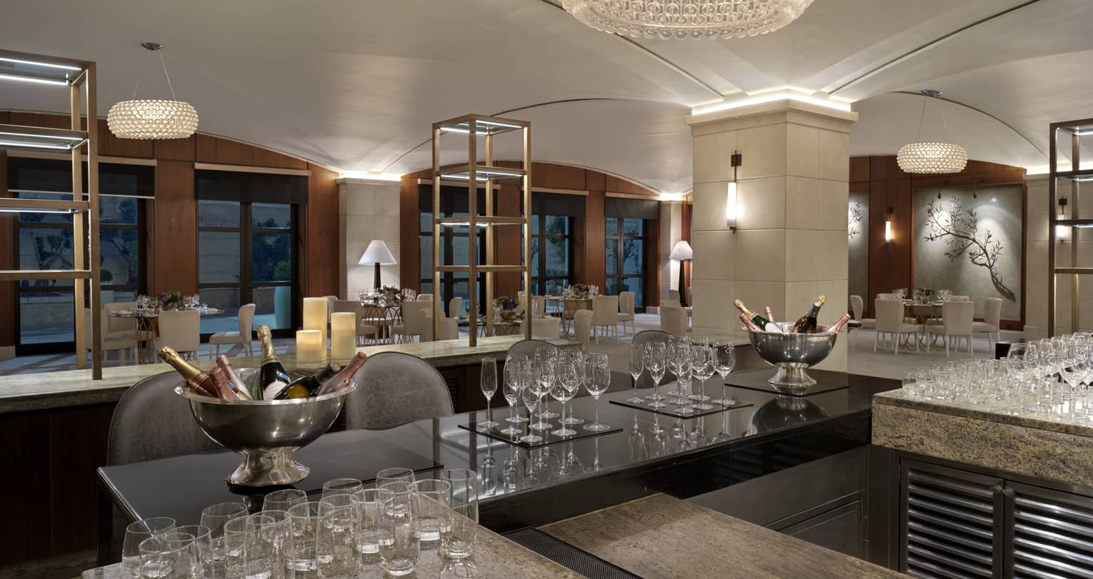 Bar counter in a private dining room with various glassware on the counter