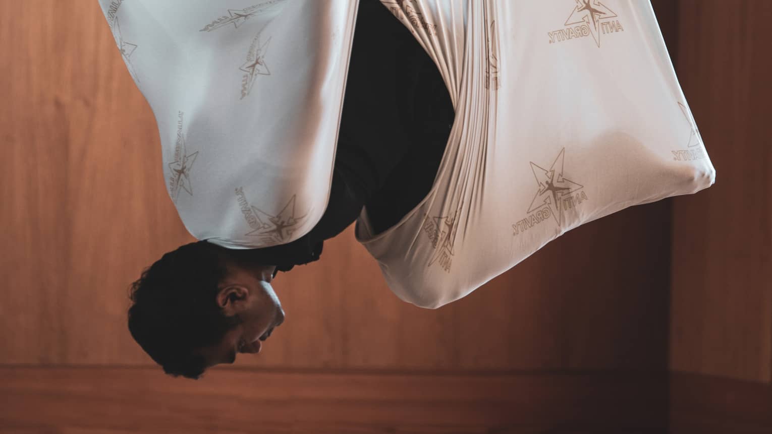 Man does aerial yoga