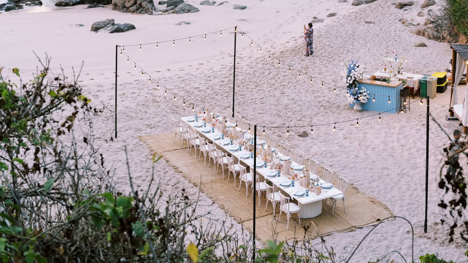 Aerial view of group dining table setup on the beach