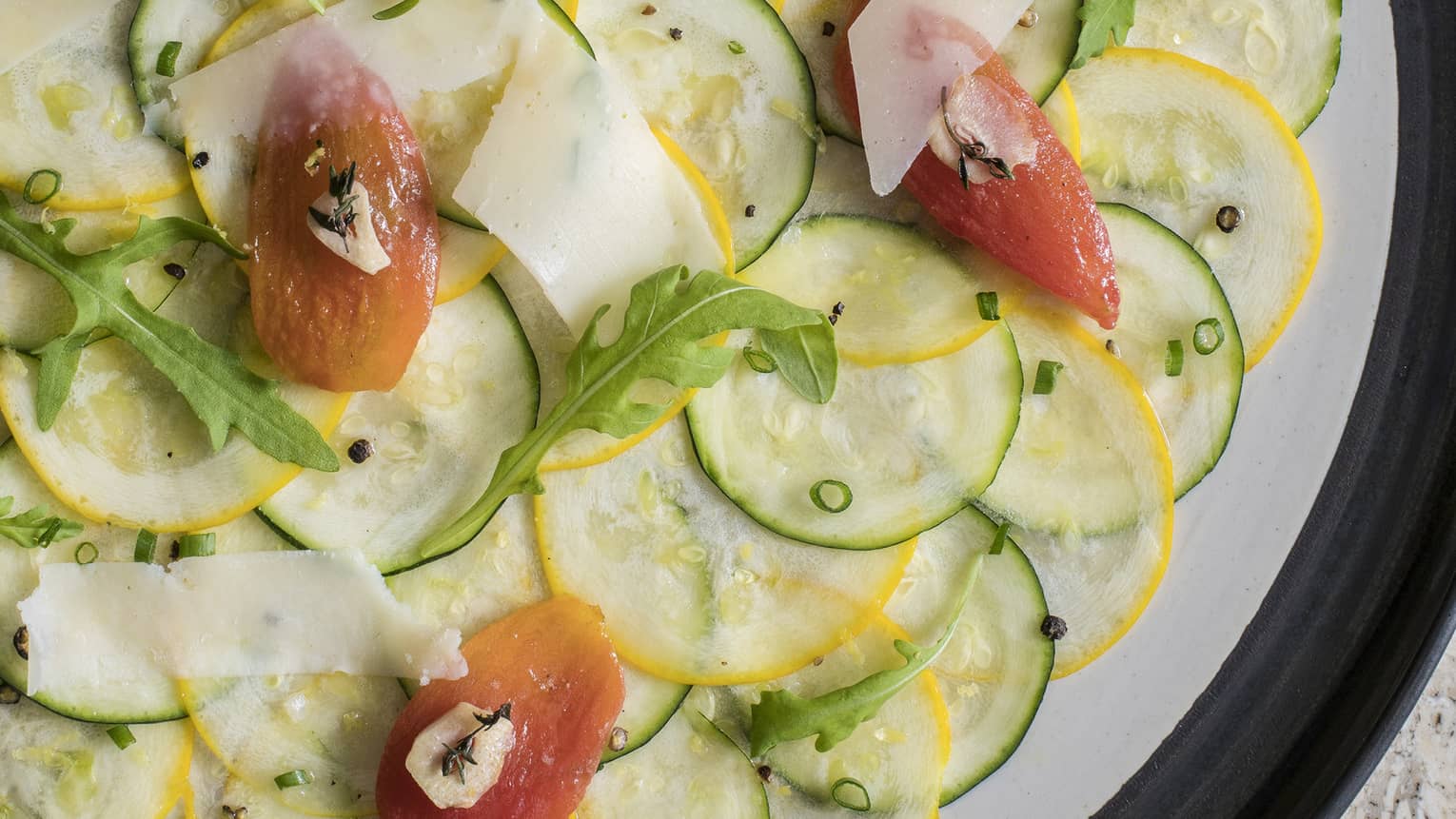Zucchini carpaccio with sun-dried tomato, parmesan, chive, lemon zest and arugula