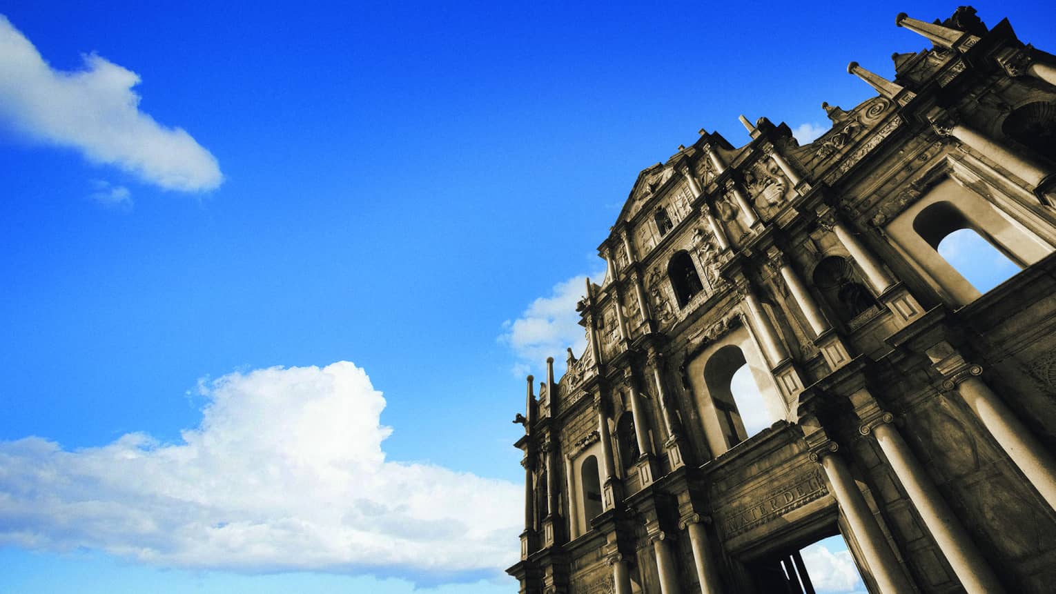Looking up at St. Paul cathedral ruins, facade against blue sky