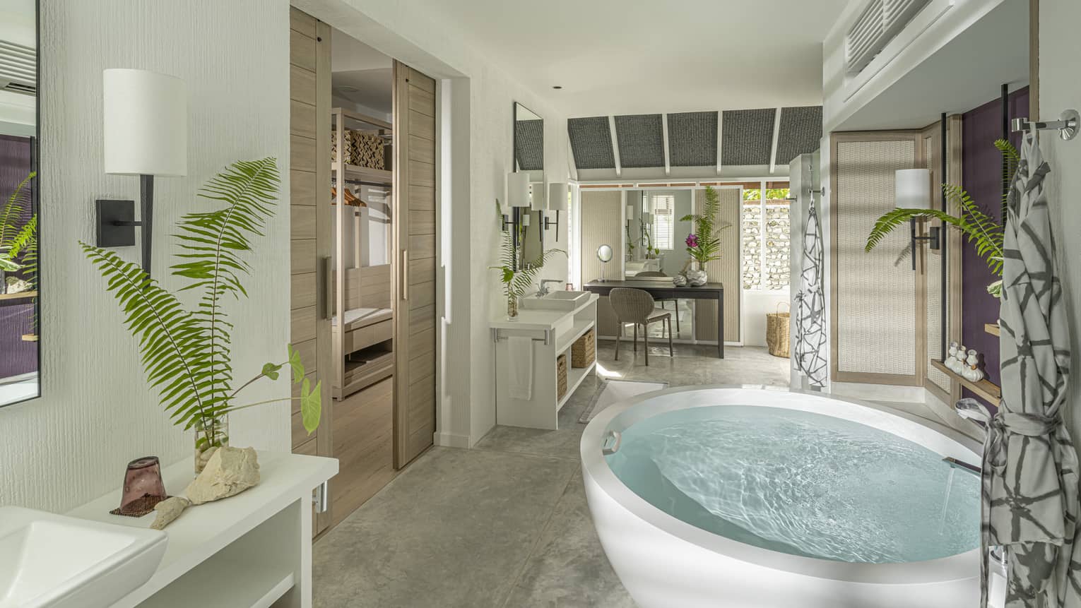 Large luxury resort bathroom with a free-standing circular tub