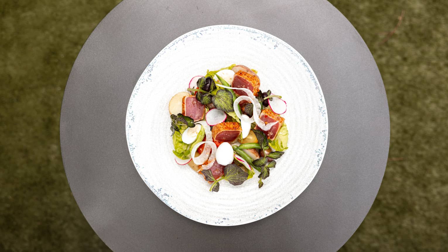 Plate of tuna and quail egg.