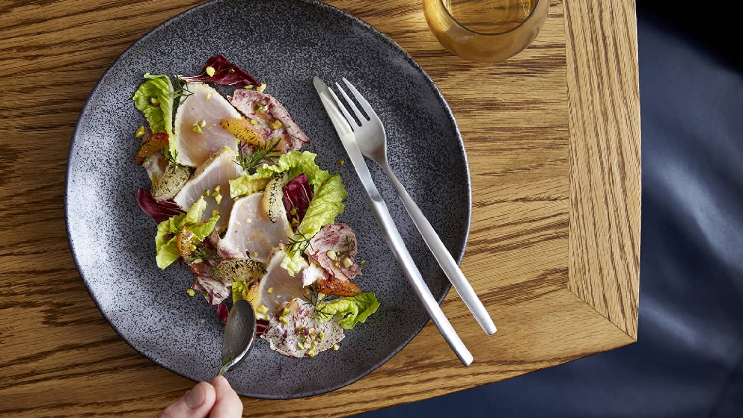 Aerial view of gourmet fresh swordfish salad with radicchio lettuce, braised citrus 