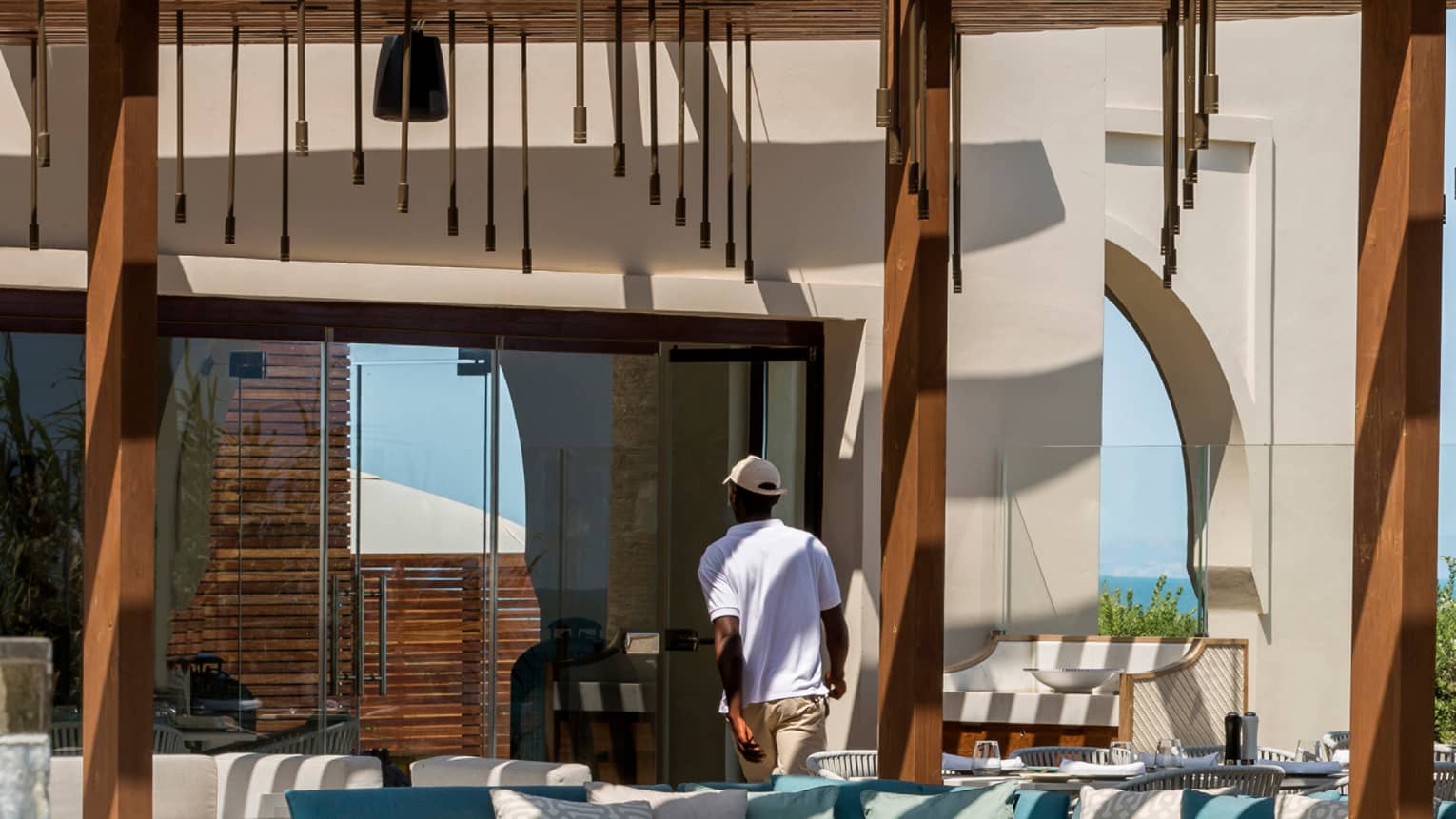 Staff serving and setting tables at poolside restaurant, Blu