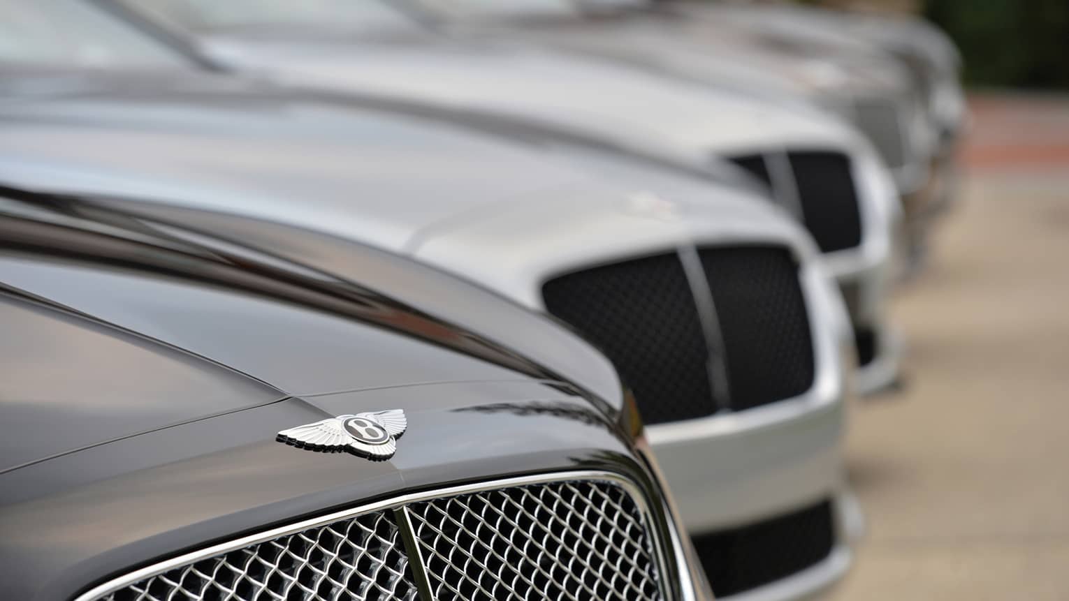 Close up of Bentley car, as part of line up of luxury cars 