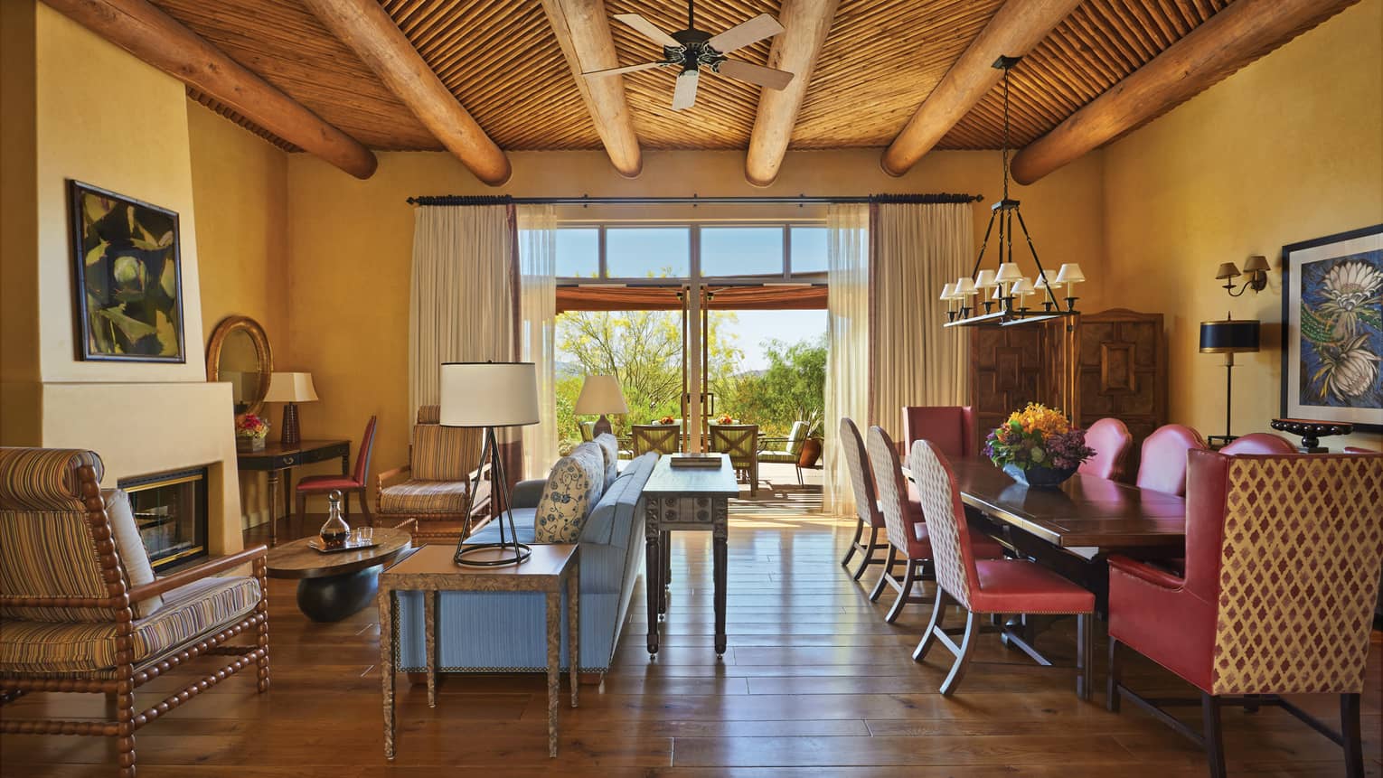 Prescott Two-Bedroom Suite large private dining table with leather chairs behind sofas, chairs under wood roof