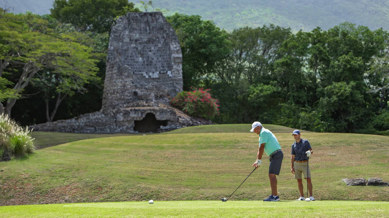 Two men playing golf.