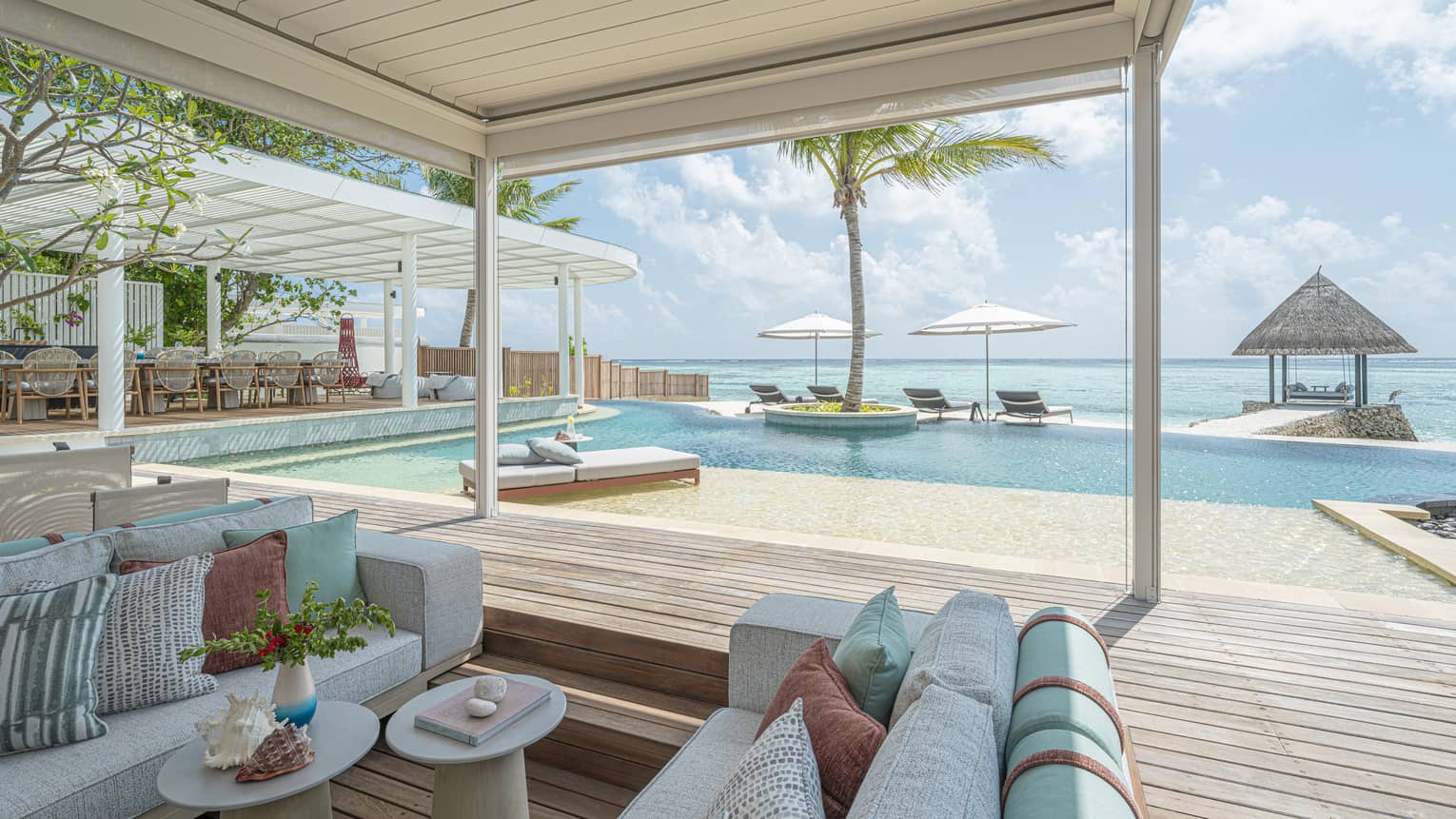 Pool terrace and covered lounge area of luxury villa in Maldives