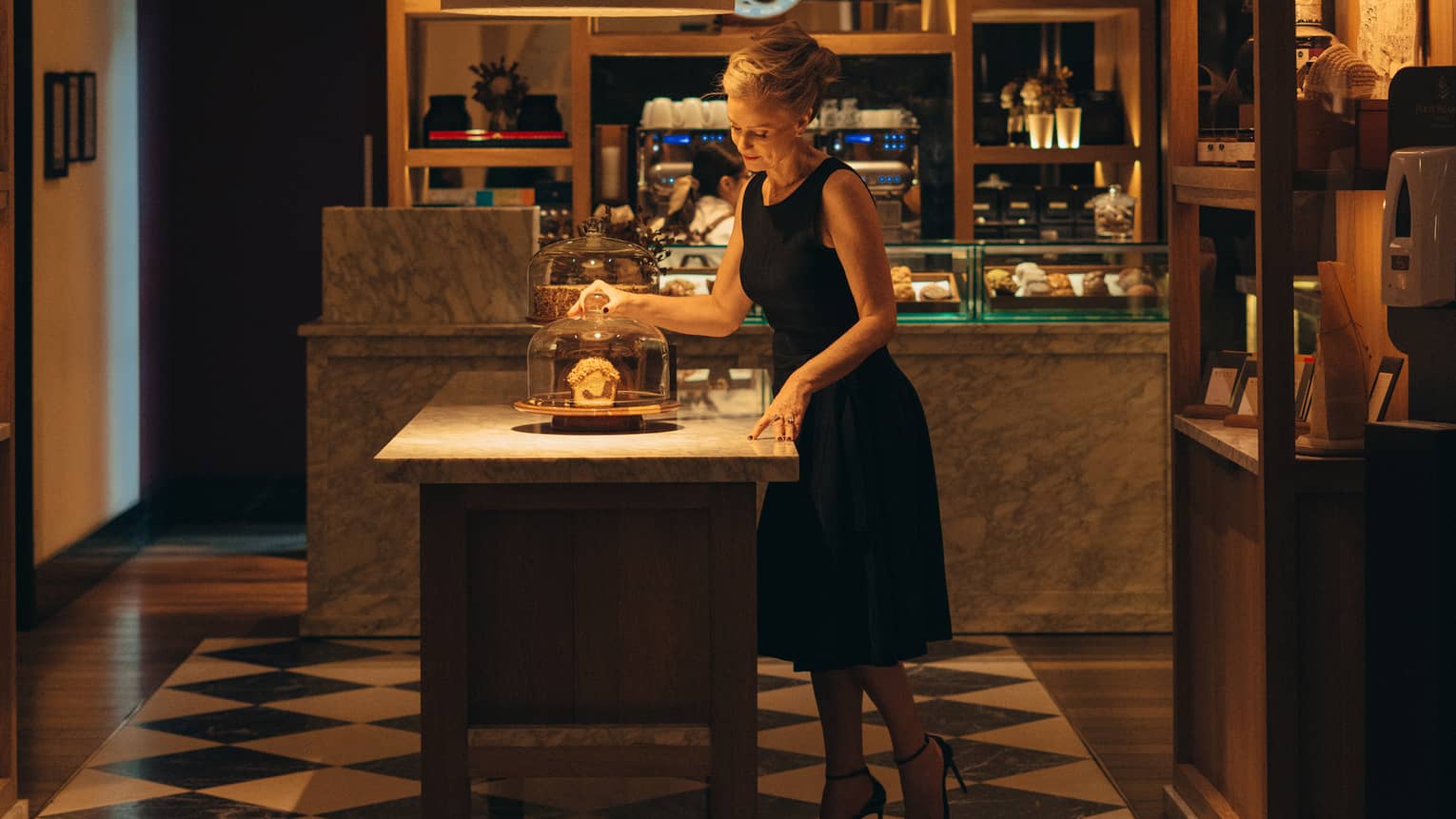 Guest wearing a dress while standing in the kitchen by the island.