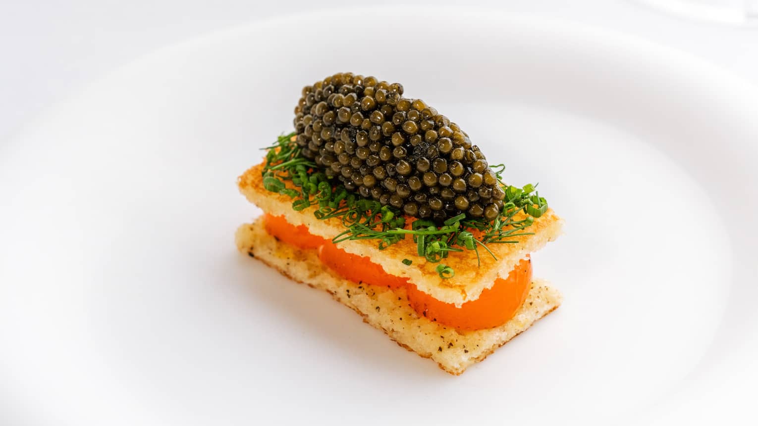 Plate of egg toast and caviar with herbs