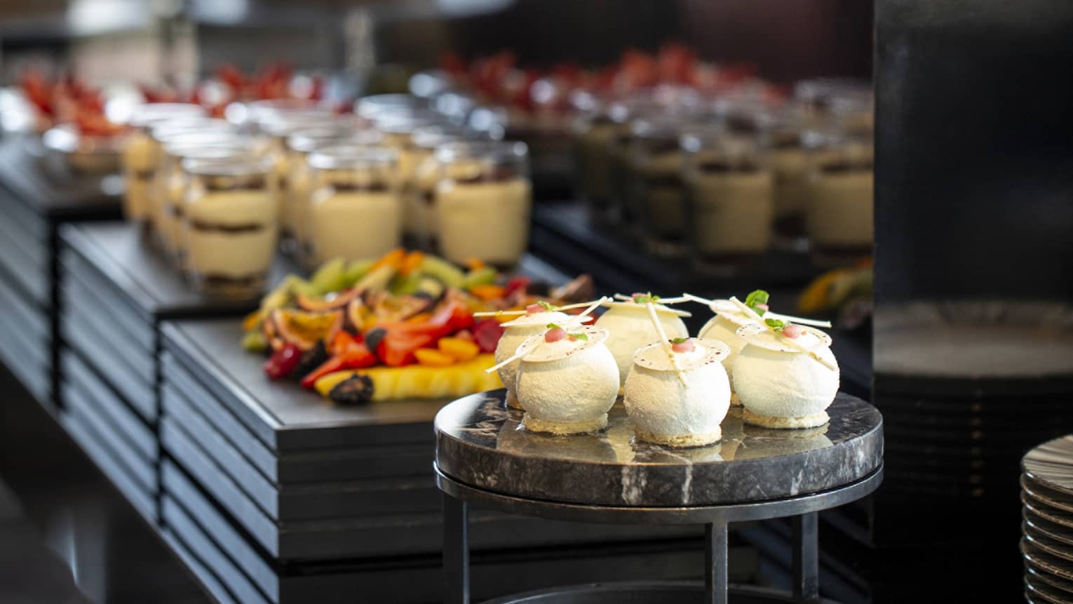 A neatly organized buffet featuring various desserts