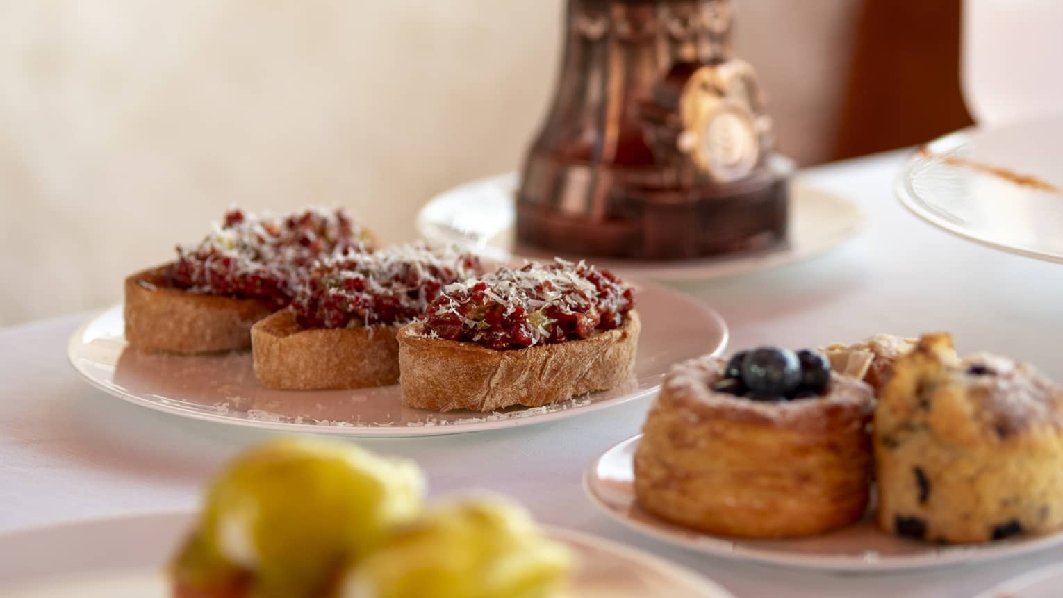 Plates of pastries on dining table