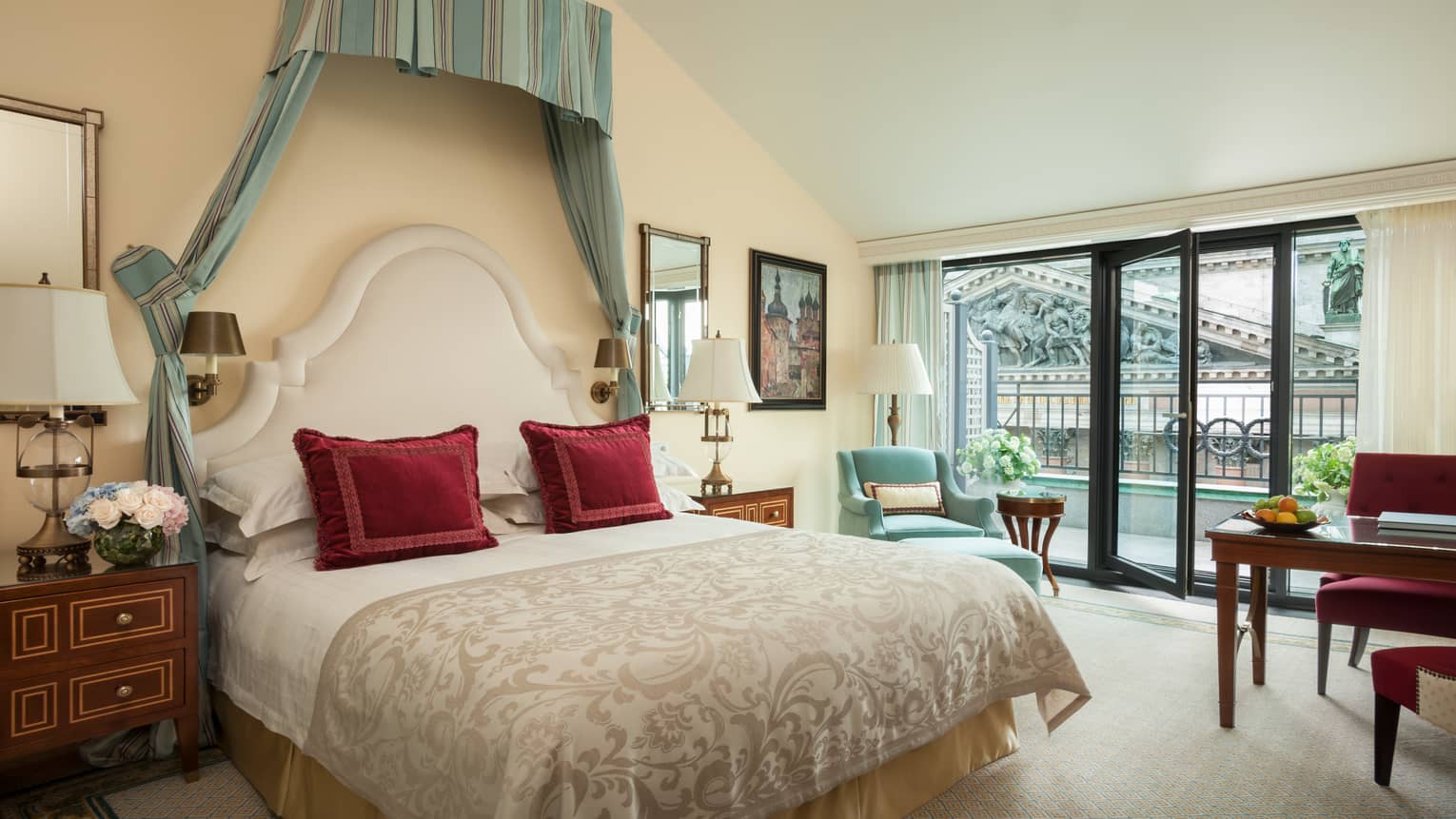 Terrace Room bed with red accent pillows under striped green and blue canopy, large window