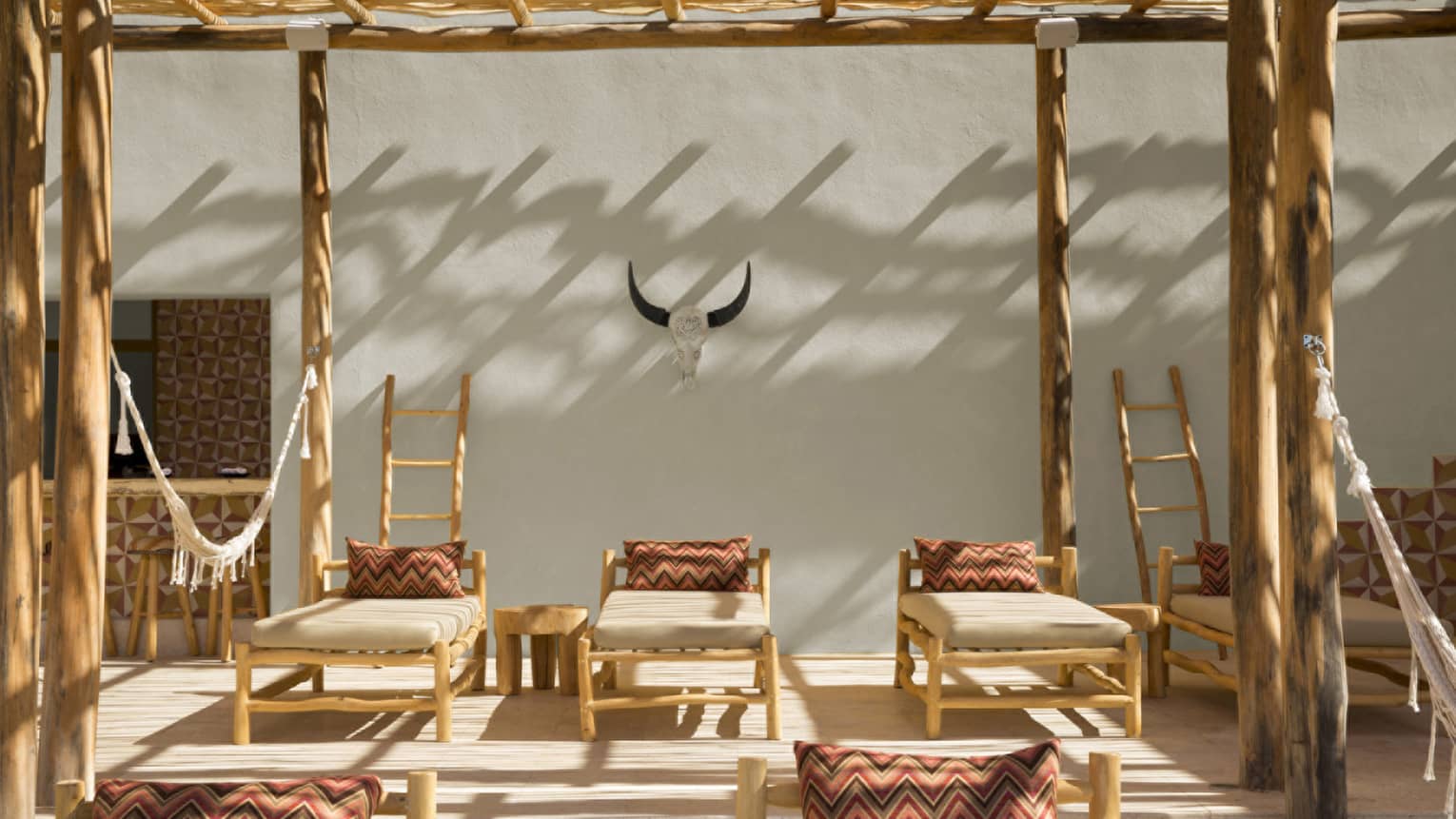 Bamboo lounge chairs with Mexican-inspired pillows on terrace