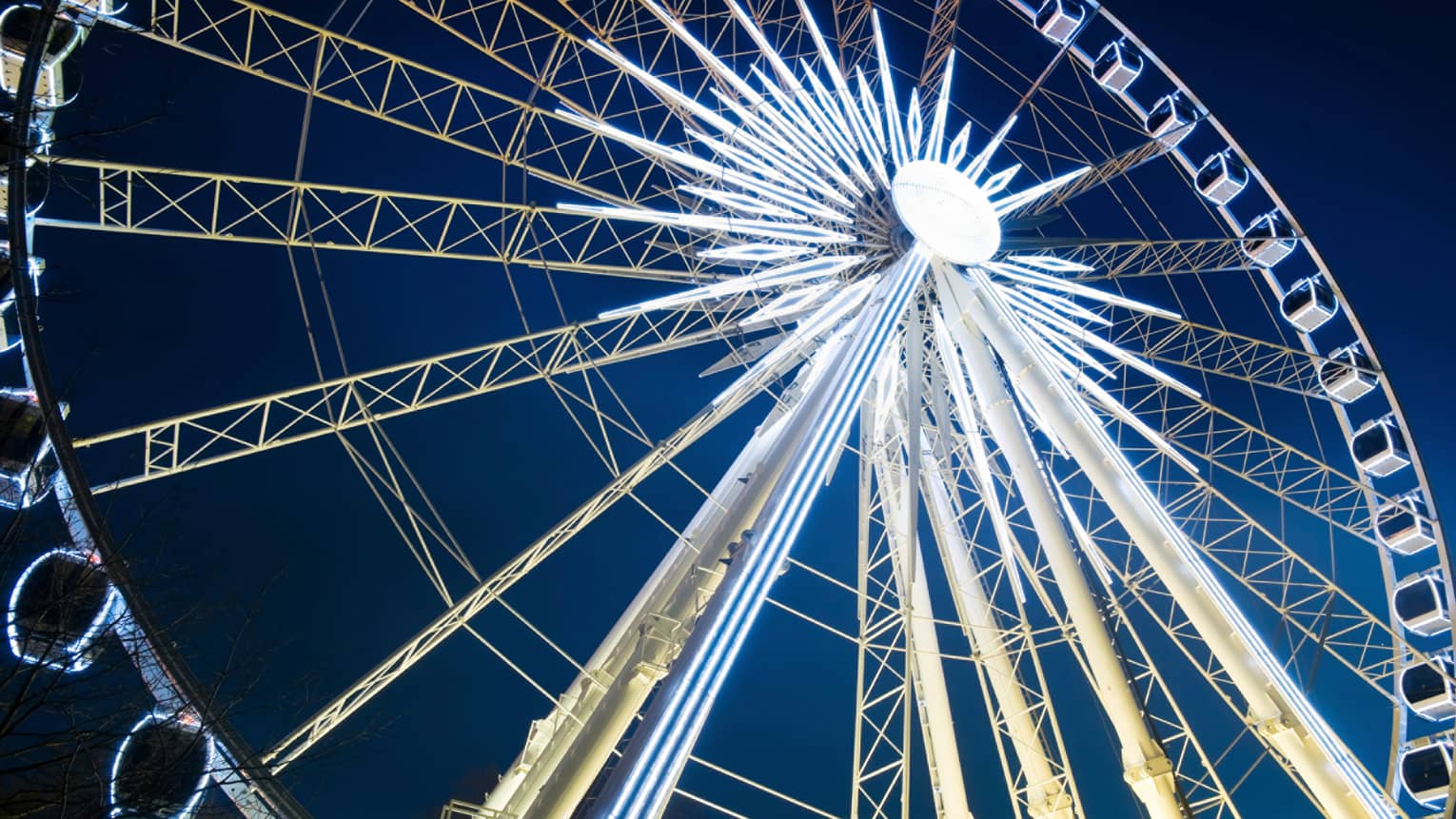 London Eye ferris wheel with lights against night sky