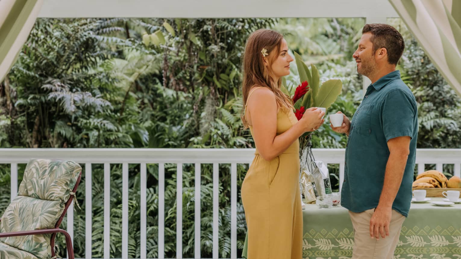 Couple enjoys fresh-brewed coffee on the balcony of a house