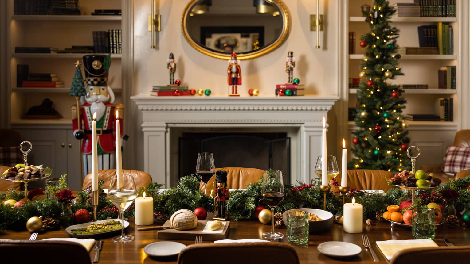Table set infront of a fireplace and bookshelves is decorated for a holiday dinner