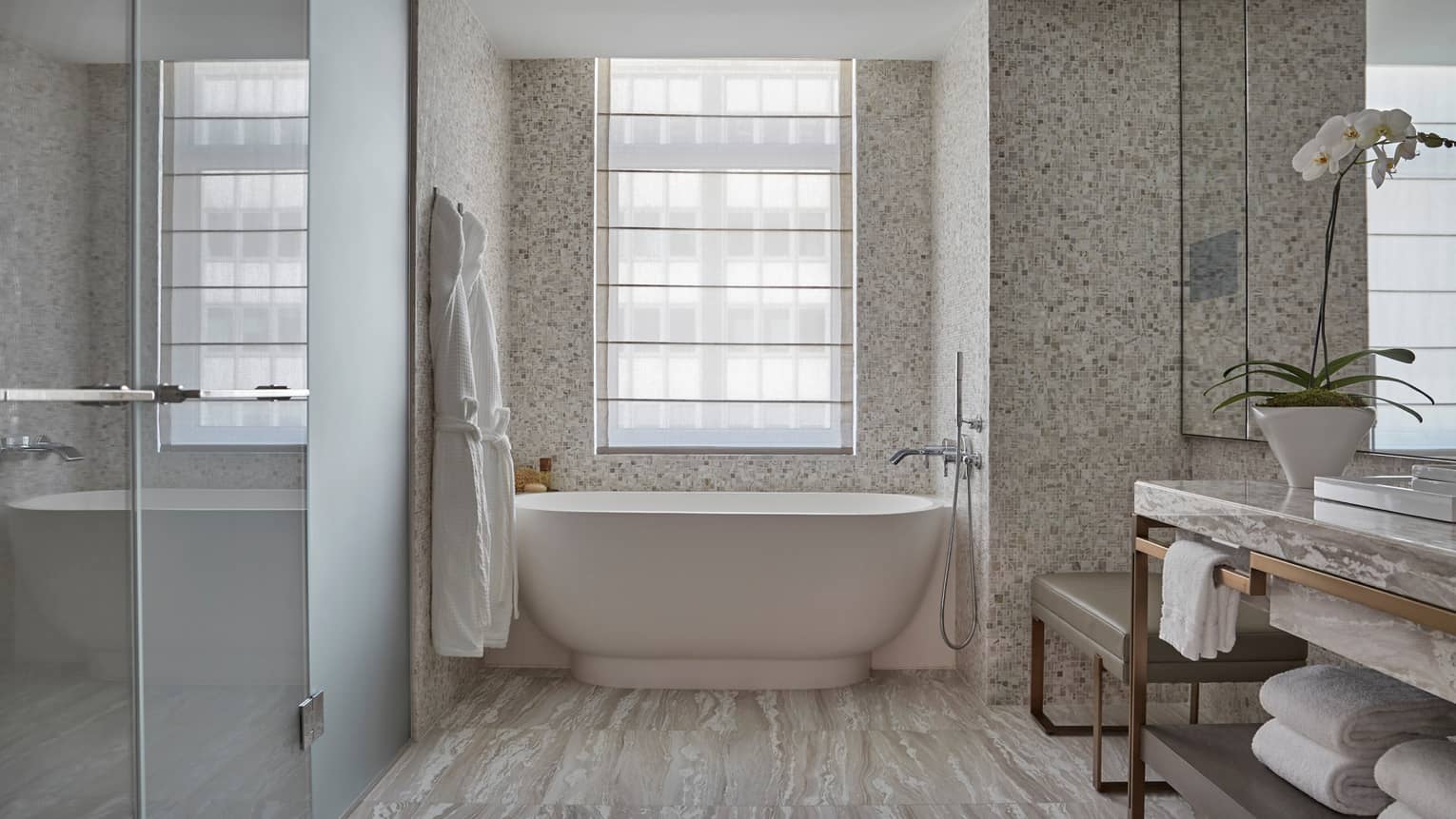 Corner Room bathroom with glass walk-in shower, white freestanding tub, vanity, white orchid