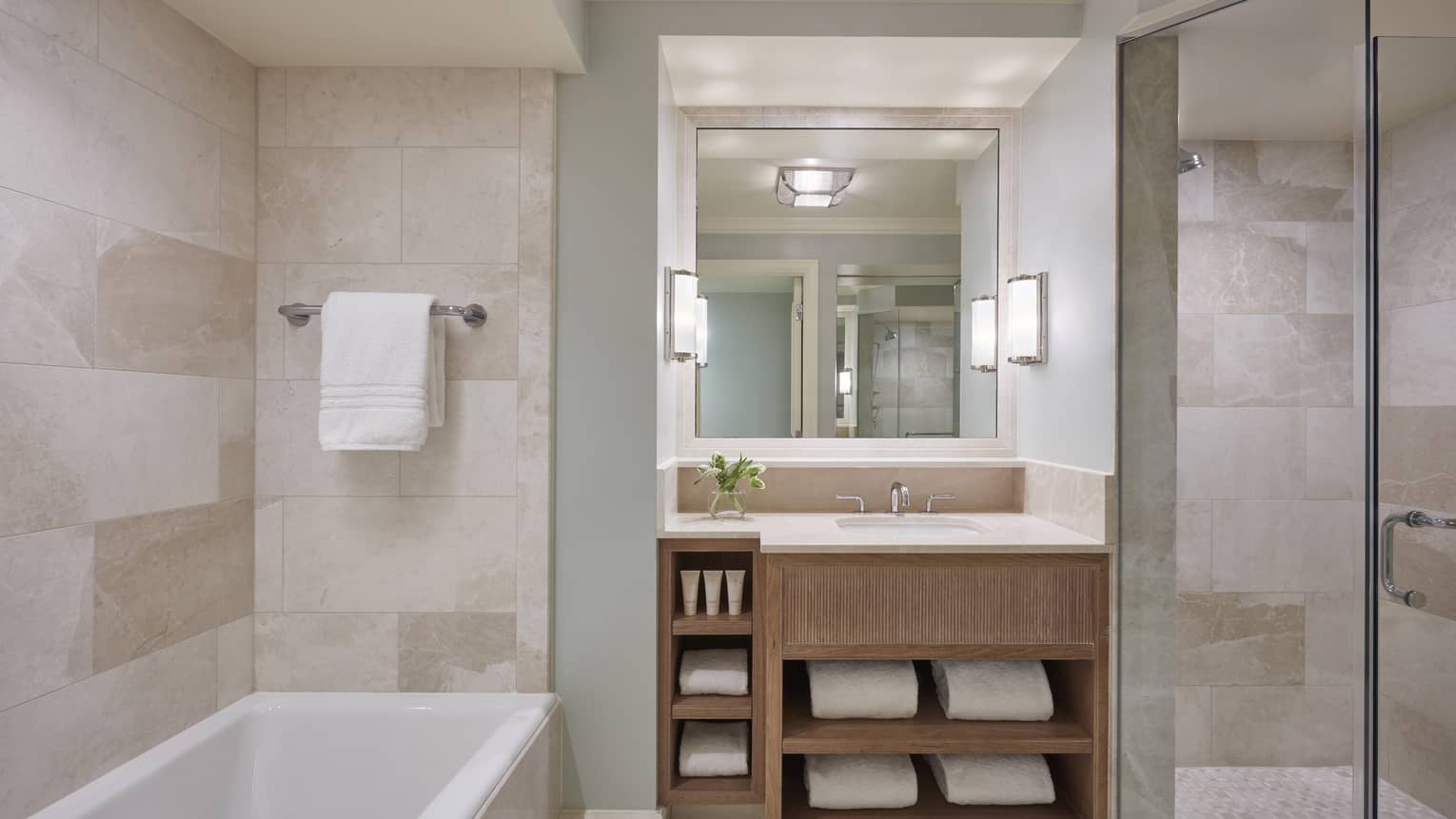 Modern hotel bathroom with a tub and marble walls