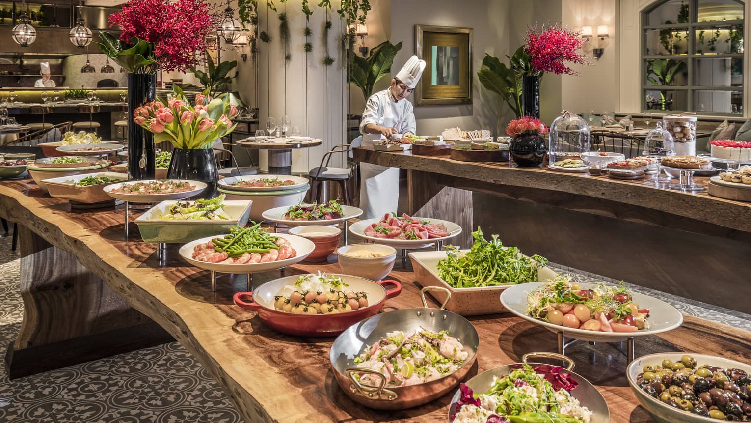 A lunch buffet arranged with platters of seafood, fresh vegetables and a large variety of other options at the One Ninety Restaurant