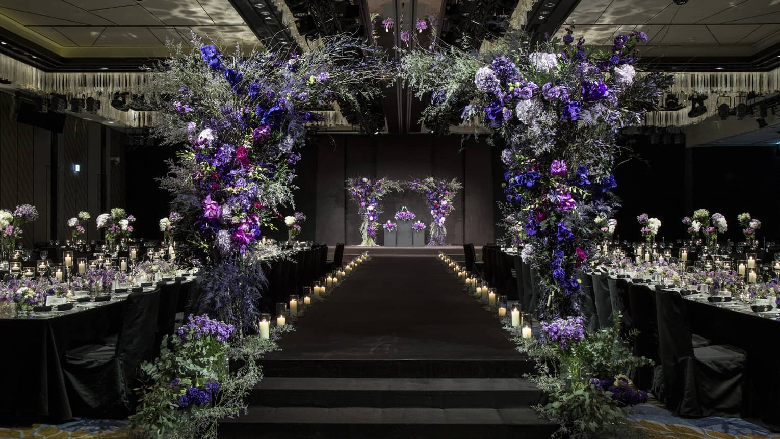 Glamourous Grand Ballroom II with candles and archway made of purple flowers