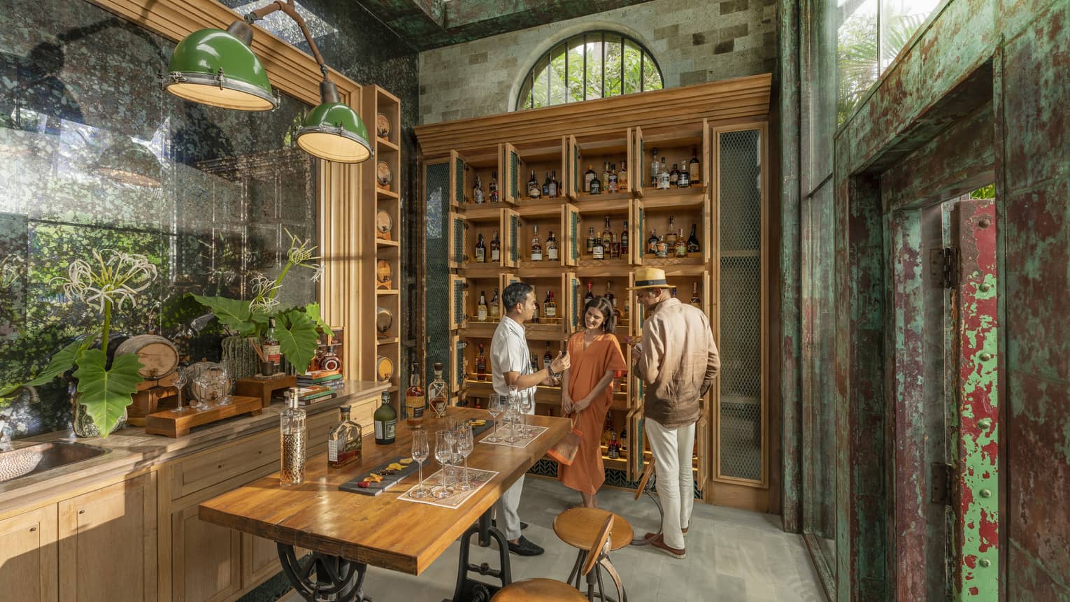 Male staff members offers samples to couple at Rum Vault