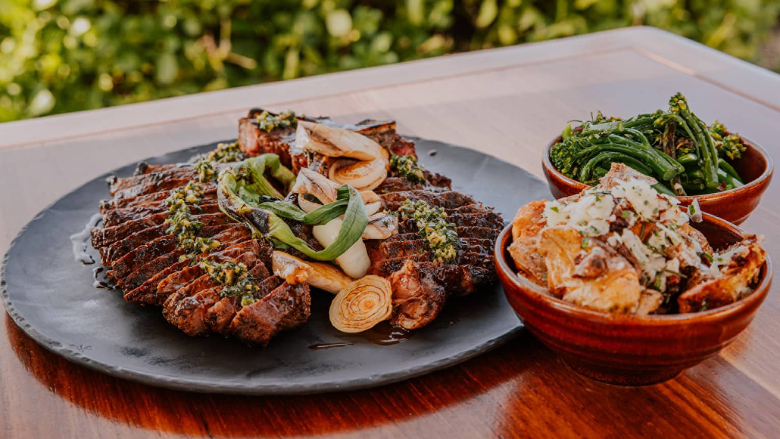 Porterhouse Steak with Salsa Verde, Garlic Confit, Kiawe Wood Smoked Salt and Red Wine Demi-Glace