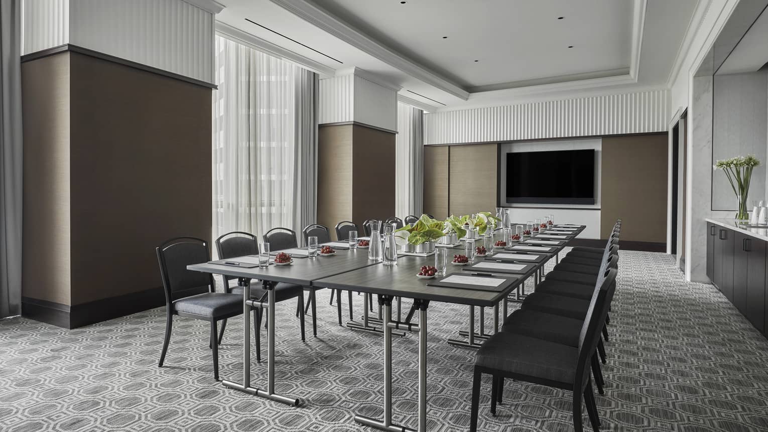 Fairfield Room, empty but ready for a meeting with one long rectangular table set with pens and paper