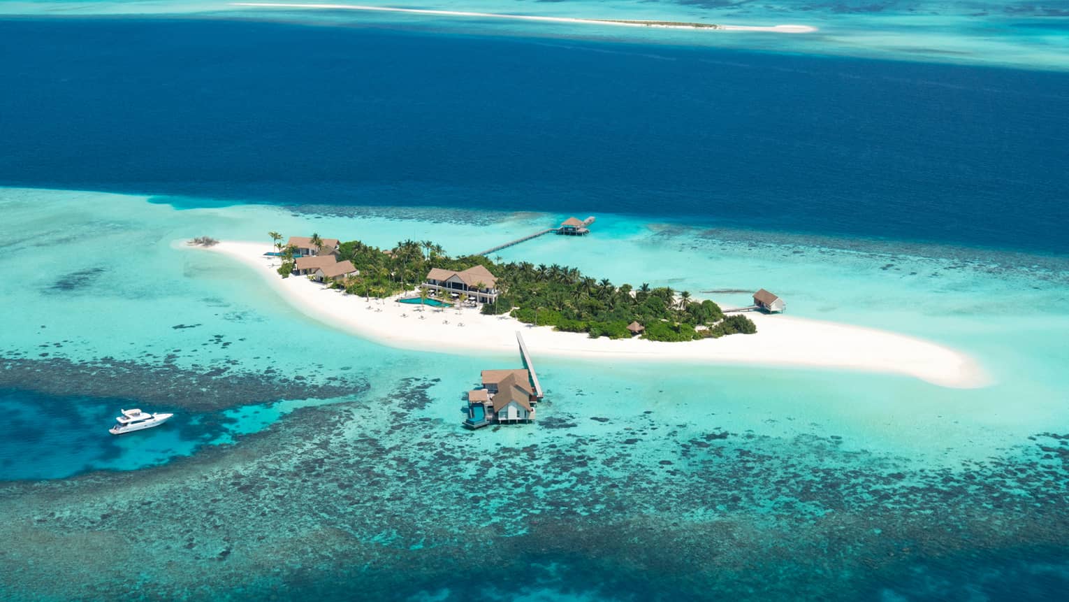 Aerial view of Maldives Private Island at Voavah, Baa Atoll with private sand beach, lagoon
