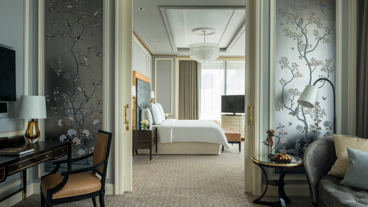 View of guest room from the parlor with queen bed, white linens, floor-to-ceiling windows