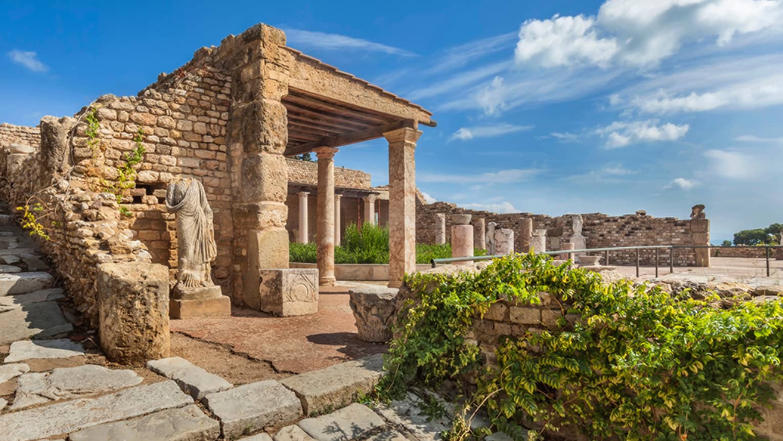 Statue under stone Ruins of Carthage, blue sky